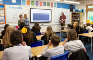 The team presenting to a school class